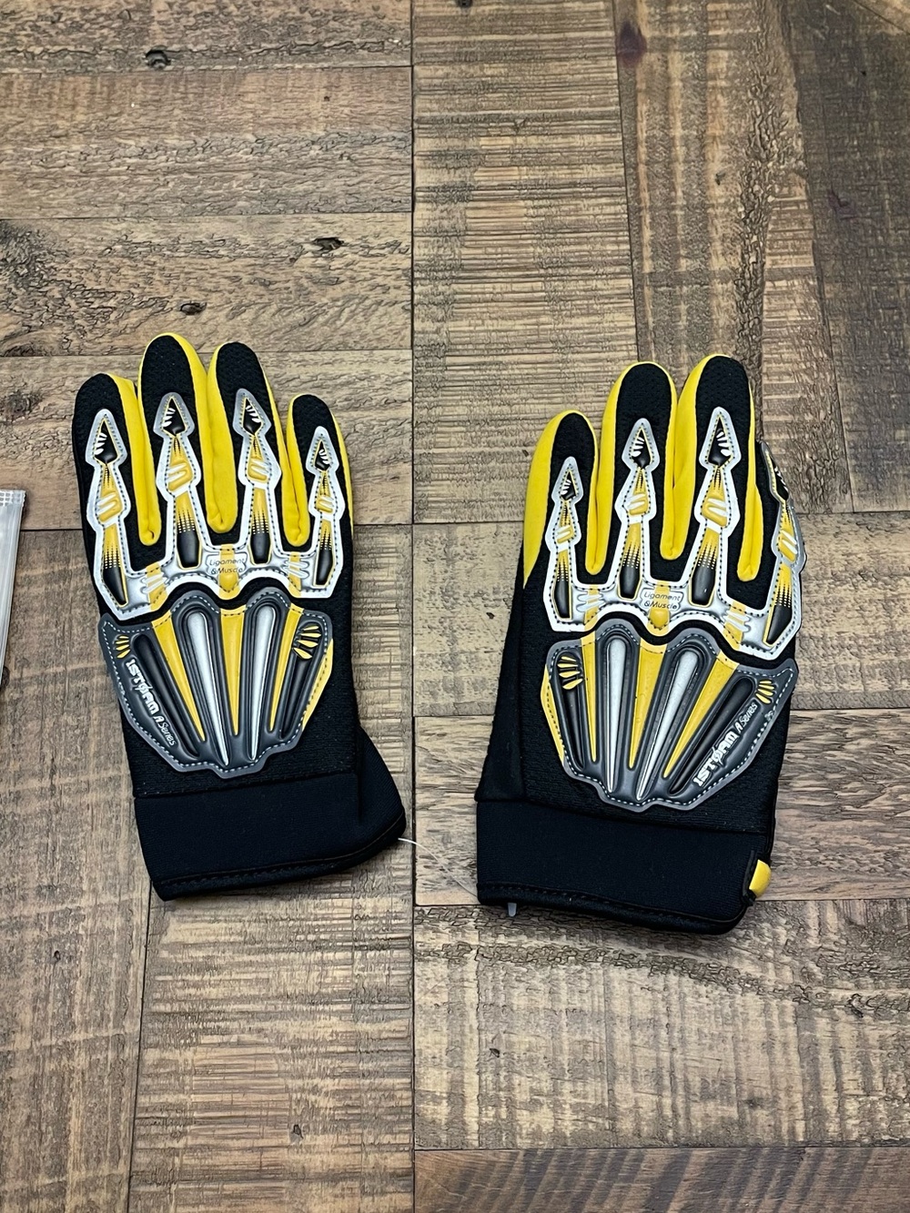 1Storm small motocross gloves featuring a yellow and black skeleton design.